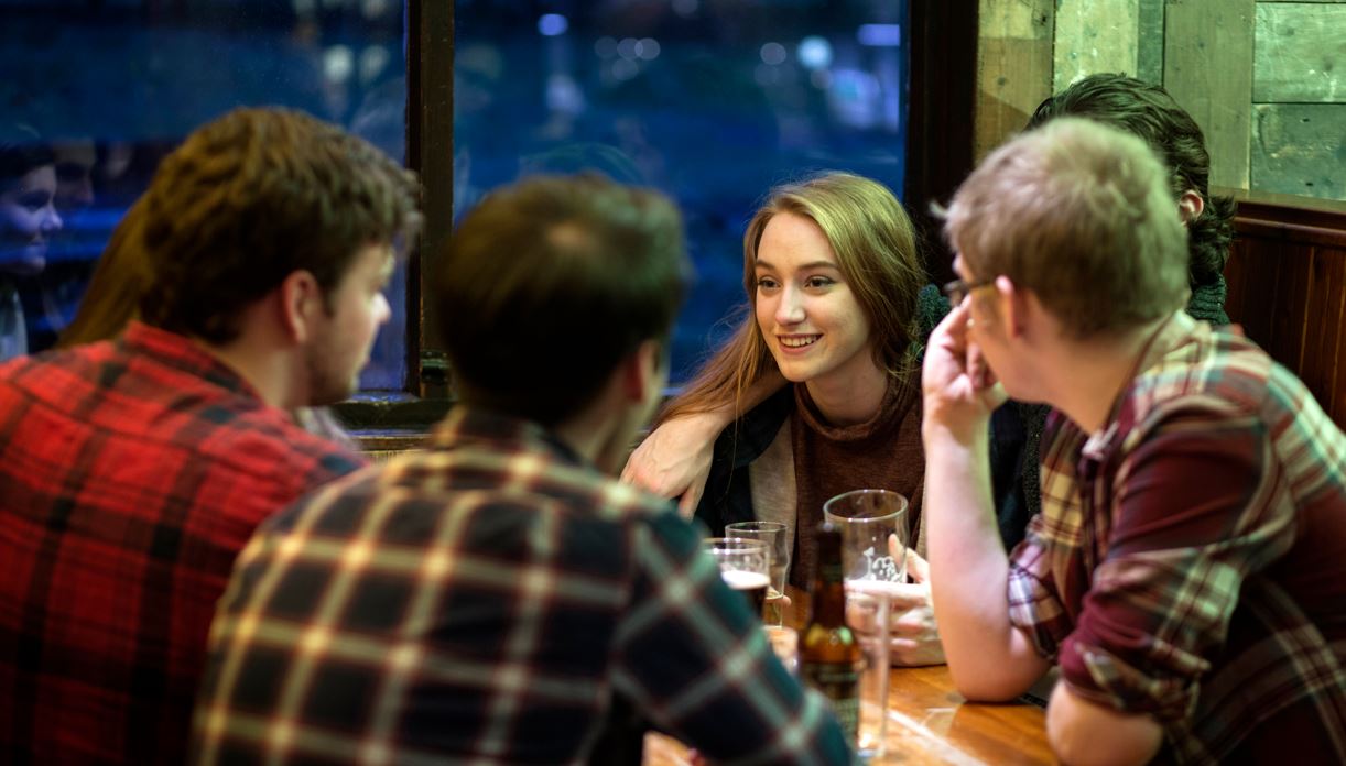 young people enjoying a drink in the bar